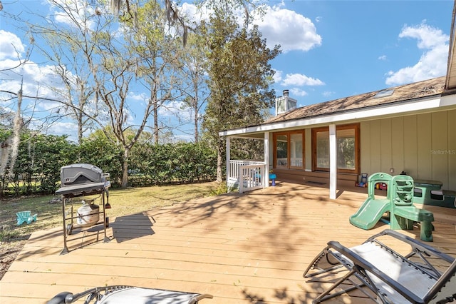 wooden deck with a grill