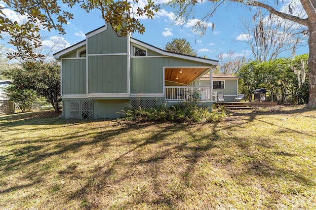 back of property featuring a lawn