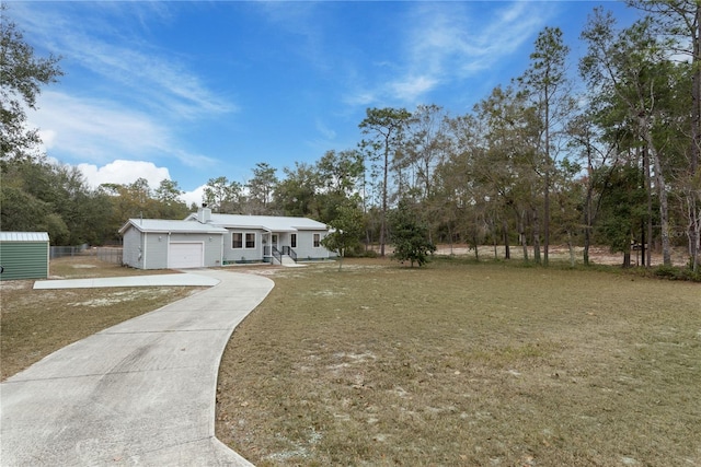 view of front of property featuring a garage and a front lawn