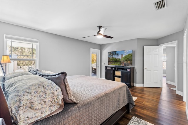 bedroom featuring baseboards, visible vents, ceiling fan, and dark wood-style flooring