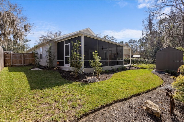 rear view of property featuring fence private yard, a sunroom, and a lawn