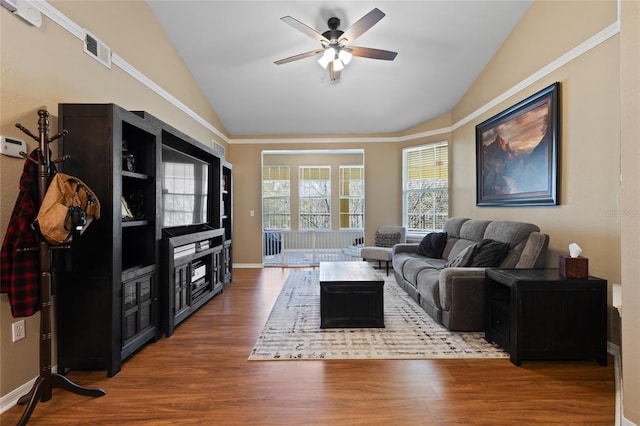 living room with lofted ceiling, visible vents, and wood finished floors