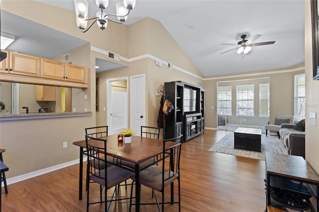 dining space featuring wood finished floors, visible vents, and baseboards