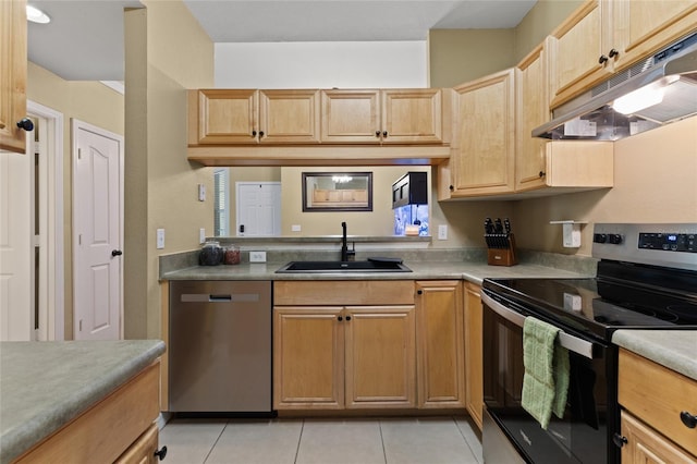 kitchen with light tile patterned floors, stainless steel appliances, light countertops, under cabinet range hood, and a sink