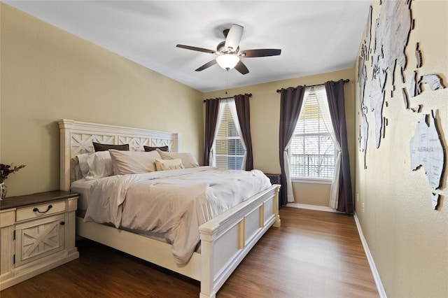 bedroom featuring dark wood-style floors, ceiling fan, and baseboards