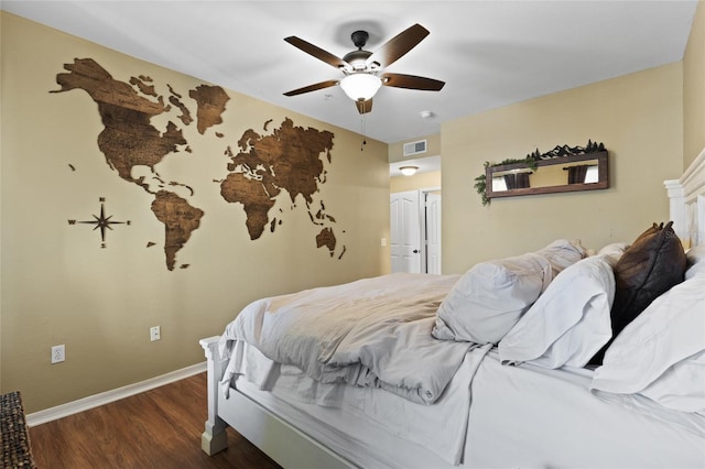 bedroom with visible vents, ceiling fan, baseboards, and wood finished floors