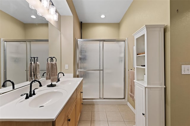 full bathroom featuring a stall shower, tile patterned flooring, and a sink