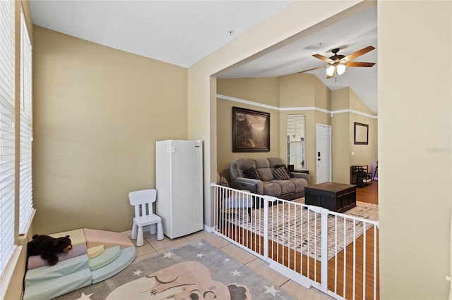 interior space with lofted ceiling and ceiling fan