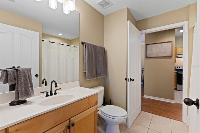 full bath with toilet, vanity, tile patterned flooring, and visible vents