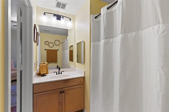 full bath with a shower with curtain, ensuite bath, visible vents, and vanity