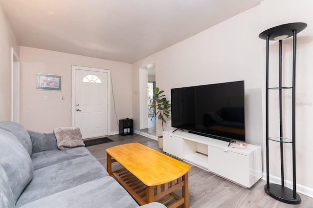 living area featuring wood finished floors and baseboards