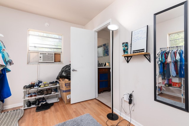 spacious closet featuring light wood-type flooring and cooling unit