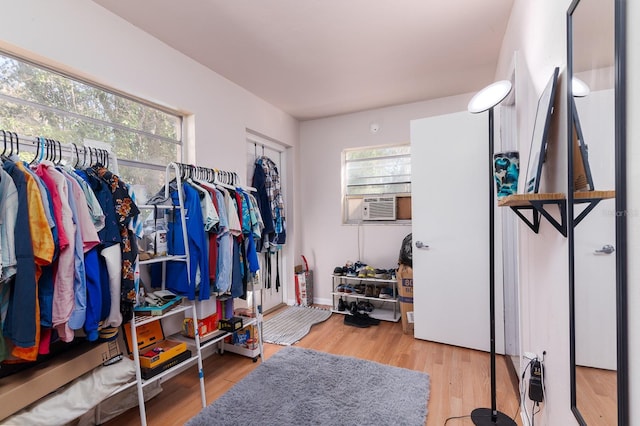 walk in closet featuring light wood-style flooring and cooling unit