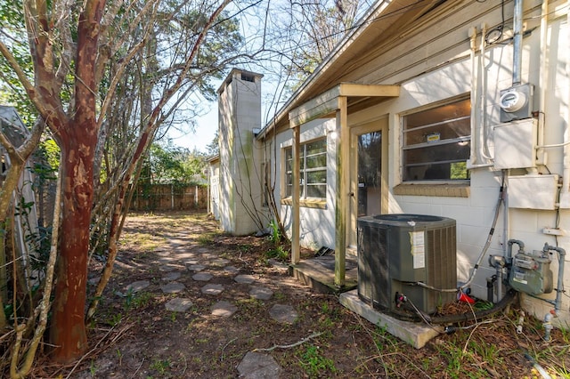 view of yard featuring fence and cooling unit