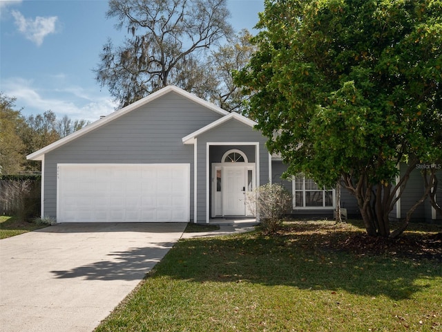 view of front of house featuring a front yard and a garage