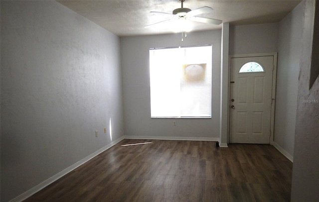 entrance foyer with dark wood-style floors, ceiling fan, and baseboards