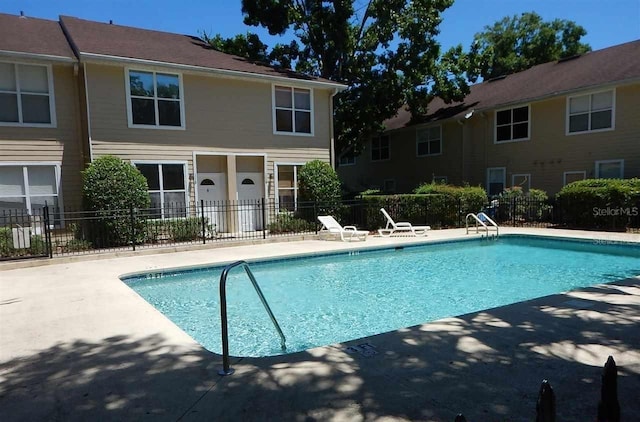 pool featuring a patio area and fence