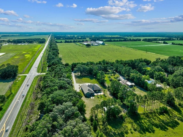 birds eye view of property with a rural view