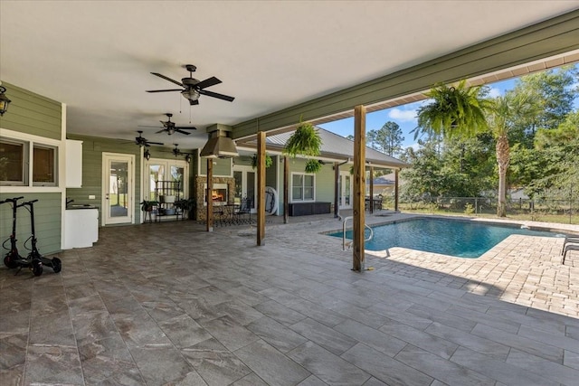 view of swimming pool with a fenced in pool, fence, a ceiling fan, and a patio