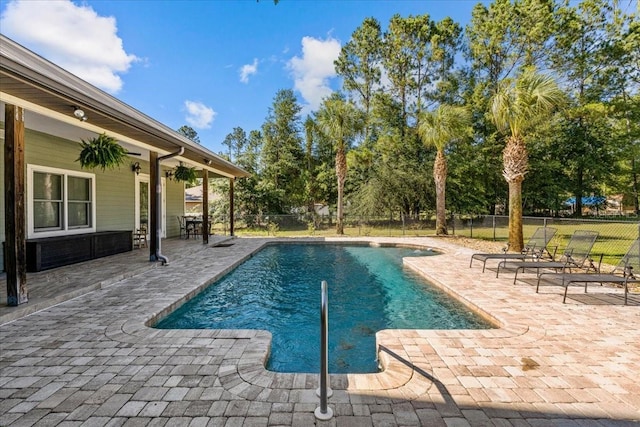 view of swimming pool with fence, a fenced in pool, and a patio