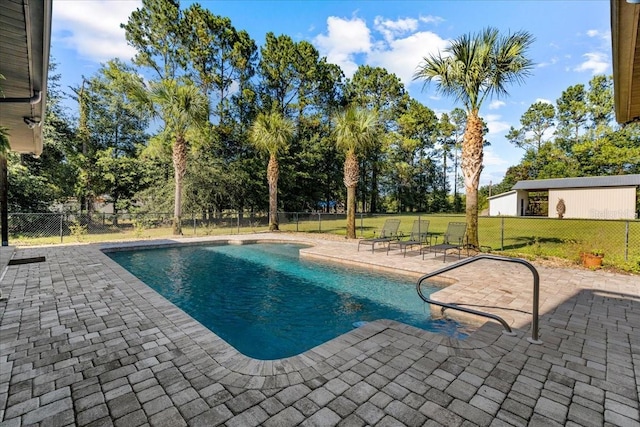 view of swimming pool with a yard, a patio area, a fenced backyard, and a fenced in pool