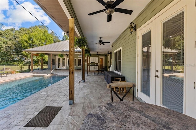 view of patio / terrace with a ceiling fan and an outdoor pool