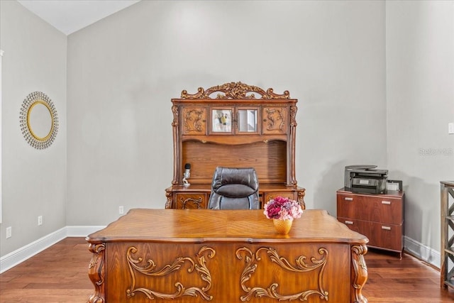 office space with baseboards and wood finished floors