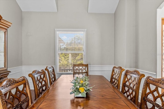 dining space featuring wainscoting