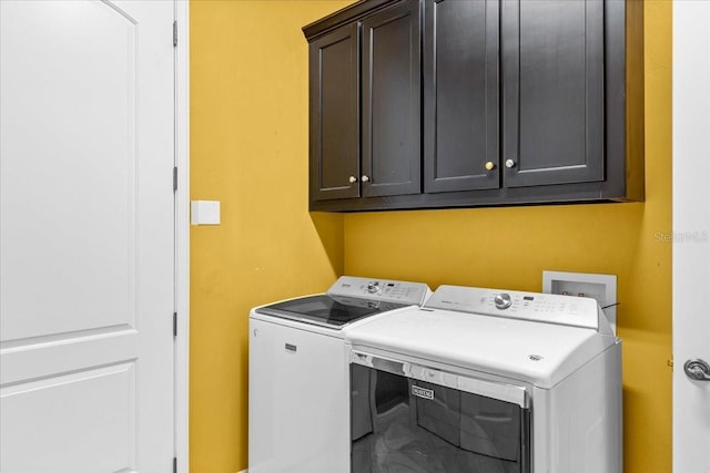 washroom featuring cabinet space and washer and dryer