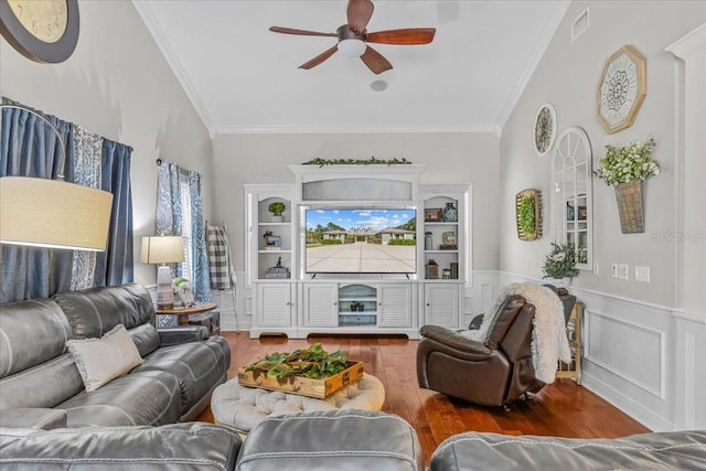 living room featuring ornamental molding, wainscoting, and wood finished floors