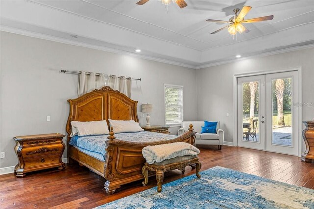 bedroom with access to outside, dark wood-type flooring, a raised ceiling, and crown molding