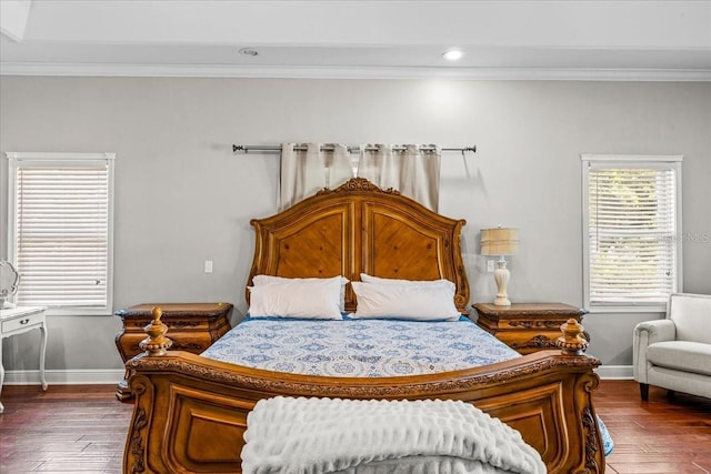 bedroom with crown molding, baseboards, and dark wood-style flooring