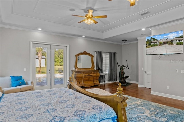 bedroom with dark wood-style flooring, a raised ceiling, visible vents, ornamental molding, and access to outside