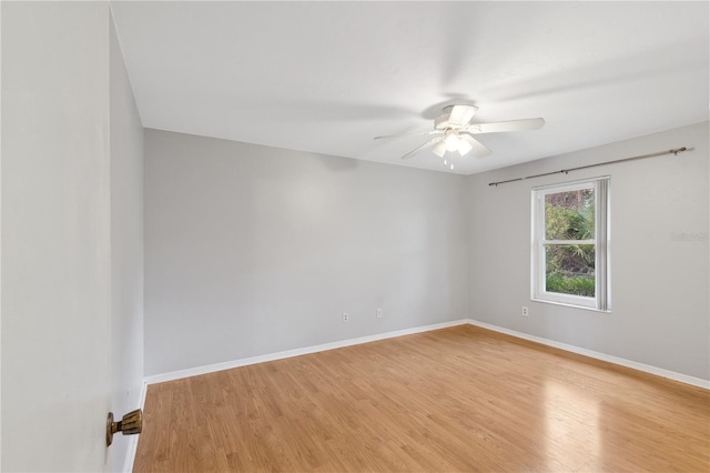 empty room featuring hardwood / wood-style floors and ceiling fan