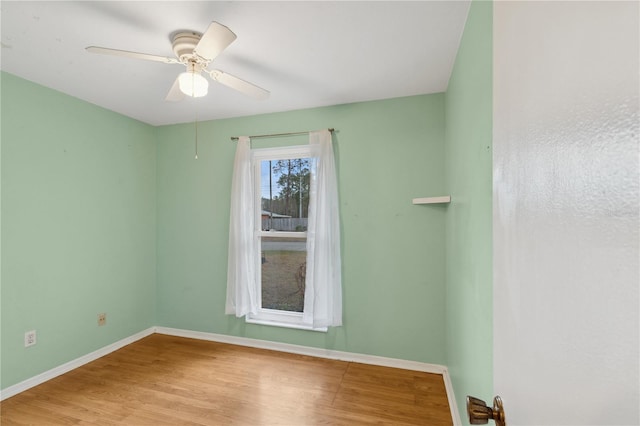 spare room with ceiling fan and light wood-type flooring