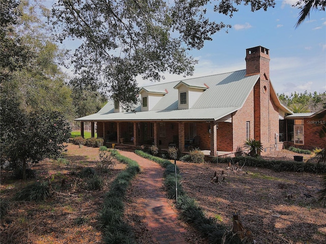 rear view of house featuring a porch