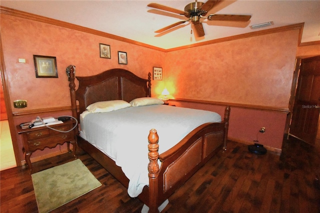 bedroom with dark hardwood / wood-style flooring, ornamental molding, and ceiling fan