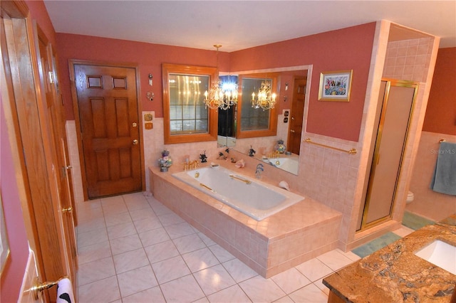 full bathroom with an inviting chandelier, tile patterned flooring, toilet, and separate shower and tub