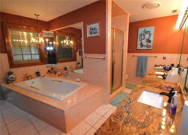 full bathroom featuring tile walls, tile patterned flooring, a chandelier, and toilet