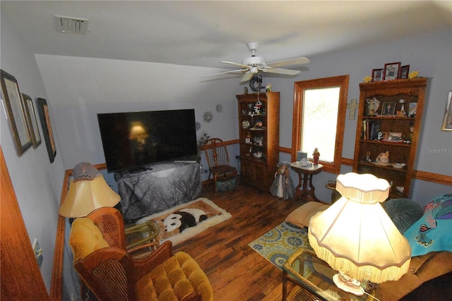 living room with dark hardwood / wood-style floors and ceiling fan