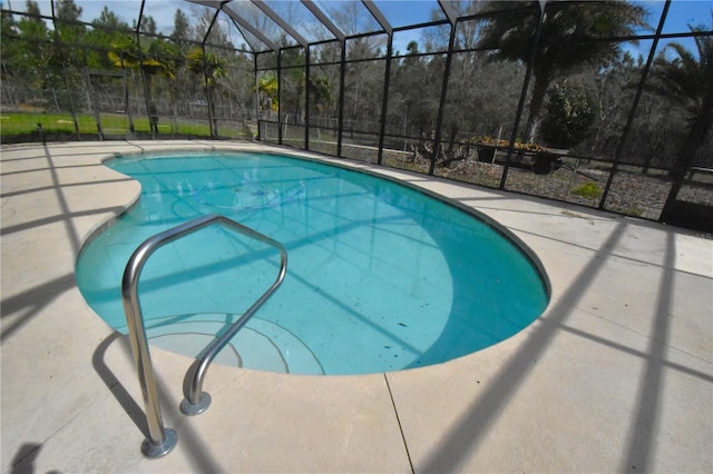 view of swimming pool with a lanai and a patio area