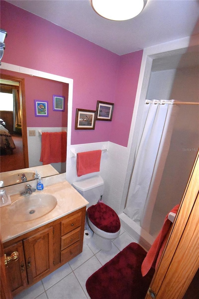 bathroom with tile patterned floors, toilet, a shower with shower curtain, and vanity