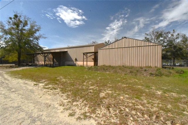 view of outbuilding featuring a lawn