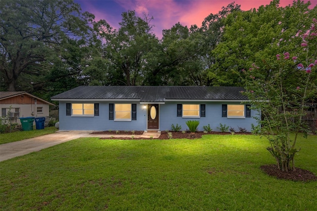 single story home featuring a lawn