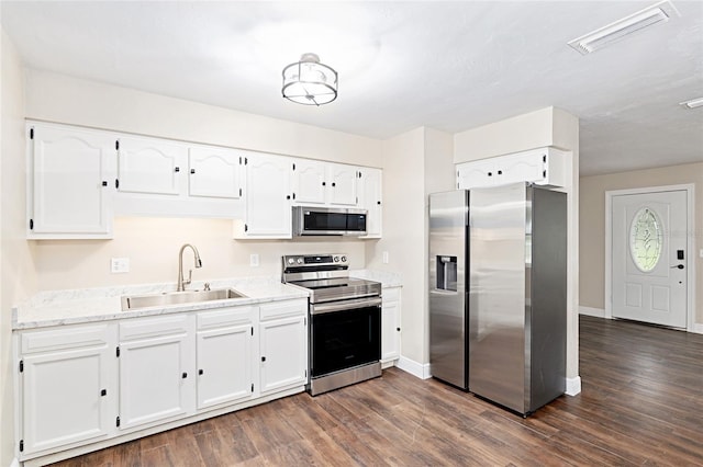 kitchen featuring dark hardwood / wood-style flooring, sink, stainless steel appliances, and white cabinets