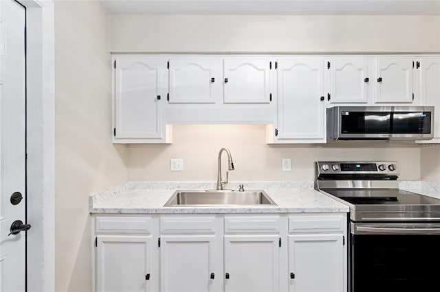 kitchen featuring white cabinetry, sink, and stainless steel appliances