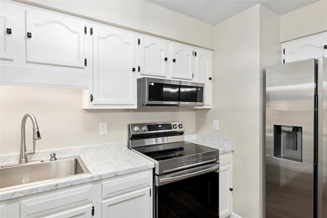 kitchen with white cabinetry, sink, and appliances with stainless steel finishes