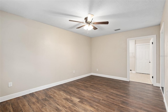 empty room with ceiling fan and dark hardwood / wood-style floors