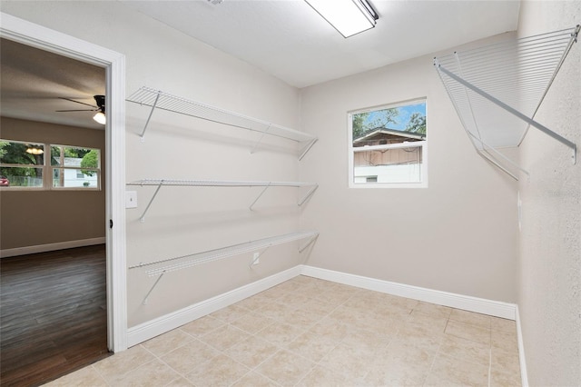 walk in closet with ceiling fan