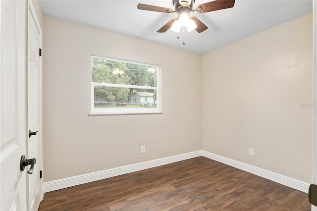 empty room with ceiling fan and dark hardwood / wood-style flooring